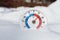 Outdoor thermometer in snow shows warm temperature hot spring we