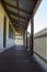 Outdoor verandah patio deck of sandstone brick cottage with picket fence in sunshine