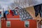 Outdoor view of clothes of Amish drying in the sun and air after laundry with a wooden red house background in Lancaster