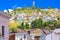 Outdoor view of colonial buildings houses located in the city of Quito with the statue of Virgin of Panecillo in the