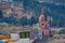 Outdoor view of gorgeus dome of ancient building located in the city of Otavalo with a mountain behind in Ecuador