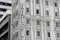 Outdoor view of Hotel sign of building with windows with curtain on white wall