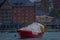 Outdoor view of red boat in Llanquihue in Puerto Varas and coastline in the distance