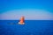 Outdoor view of the red lighthouse on the Norwegian sea over a rock