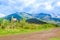 Outdoor view of sign at one side of the road, with huge mountain in the horizont, imbabura inactive stratovolcano in