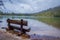 Outdoor view of wooden chair in the lakeshore located in gran teton, beautiful landscape with the string lake and the