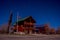 Outdoor view of wooden house in a gorgeous night photography Bryce Canyon with moonlight and sky stars