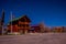 Outdoor view of wooden house in a gorgeous night photography Bryce Canyon with moonlight and sky stars