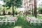 Outdoor wedding ceremony, chairs decorated with flowers