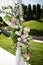 Outdoor wedding ceremony. Wedding chuppa decorated with fresh flowers