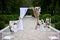 Outdoor wedding decorations, arch decorated with red and white flowers, chairs, lanterns