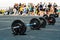 Outdoor weightlifting competition. Barbells with a lot of weight against the backdrop of a crowd of spectators. Unrecognizable