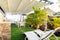 Outdoor white dining table and dining chair on green artificial glass under the roof at rooftop terrace