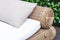 Outdoor wicker bed with white mattress and grey pillow