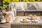 An outdoor wicker table and a sofa with cushions. Croissants for