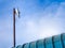 Outdoor wireless access point on the rusty pole with blue sky view background.