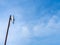 Outdoor wireless access point on the rusty pole with blue sky view background.