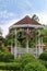 Outdoor wooden gazebo with flowers in a beautiful garden