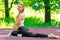 Outdoor yoga in the park, portrait of a beautiful girl leading