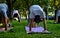 Outdoor yoga - people practicing yoga  in the park