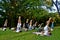 Outdoor yoga - people practicing yoga  in the park