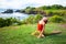 Outdoor yoga practice. Young woman practicing Ardha Kapotasana, Half Pigeon Pose. Chest opener improving breathing. Tanah Lot