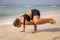 Outdoor yoga. Strong Caucasian woman practicing Parsva Bakasana, Side Crow Pose. Arm balance and concentration. Yoga retreat.