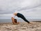 Outdoor yoga. Young woman practicing Chakrasana or Urdhva Dhanurasana. Full Wheel Pose. Deep backbend. Flexibility, strength,