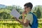 Outdoors, a boy schoolboy gnaws an apple and reads a book