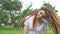 Outdoors female portrait of a modern girl with dreadlocks wearing white shirt in a city park during a sunset, be free