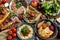 Outdoors Food Concept. Appetizing barbecued steak, sausages and grilled vegetables on a wooden picnic table.