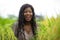 Outdoors fresh portrait of young beautiful and happy black afro American woman in cool dress having fun at tropical rice field