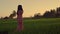 Outdoors gimbal shot on young beautiful and happy Asian Chinese woman in stylish Summer dress walking on rice field nature