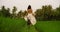 Outdoors holidays portrait of attractive and happy Asian woman in white dress enjoying beauty of nature walking her dog at