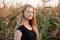 Outdoors lifestyle portrait of young adorable fresh looking redhead woman with freckles gorgeous extra long hair corn field sunny