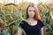 Outdoors lifestyle portrait of young adorable fresh looking redhead woman with freckles gorgeous extra long hair corn field sunny