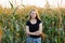 Outdoors lifestyle portrait of young adorable fresh looking redhead woman with freckles gorgeous extra long hair corn field sunny