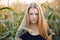 Outdoors lifestyle portrait of young adorable fresh looking redhead woman with freckles gorgeous extra long hair corn field sunny