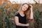 Outdoors lifestyle portrait of young adorable fresh looking redhead woman with freckles gorgeous extra long hair corn field sunny