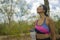 Outdoors lifestyle portrait of young attractive tired and thirsty Asian woman drinking water after hard running workout cooling