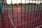 Outdoors mini football and basketball court with ball gate and basket surrounded with high protective fence