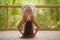 Outdoors natural portrait of young attractive and happy red hair woman doing yoga at tropical fitness studio practicing balance