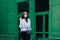 Outdoors portrait of beautiful young brunette girl. Teenage glamour girl with sunglasses wearing trendy outfit posing in city