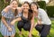 Outdoors portrait of daughter, mother and grandmother having fun in their garden.