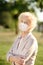 Outdoors portrait senior woman wearing disposable medical face mask. Safety in public place during coronavirus outbreak