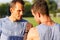 Outdoors portrait of serious strong men shake hands before competition