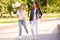 Outdoors portrait of two delightful young woman. Two caucasian girls friend stroll and chat together in sunny day