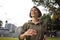 Outdoors portrait of young attractive and active  jogger woman in hoodie top  running and jogging in morning workout at beautiful