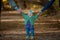 Outdoors small breasted girl 1 year of age holding parents hand and smiling