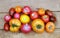 Outdoors still life with ripe red and orange tomatoes on brown wooden table surface as background top view
